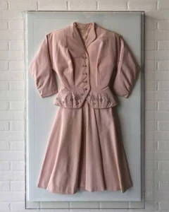 Acrylic Box, A dress hanging on the wall in front of a door.