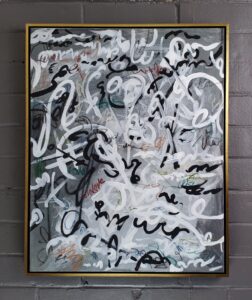 abstract with swirling lines in black grey and white. framed in a yellow gold watergilded floater frame.