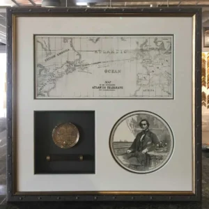 A framed picture of an old photo and a coin.