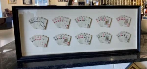 A wall with many playing cards on it