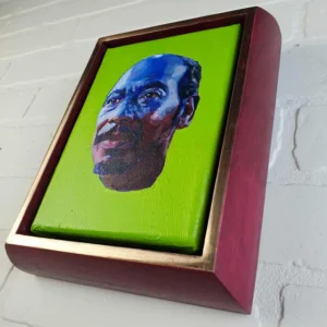 A painting of a man 's face on a wall.