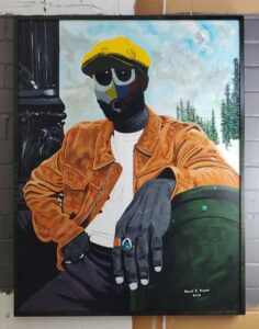 figure in yellow cap wearing a white tee and brown coat. his skin is grey. his hand in the foreground is large and he is wearing two rings on the index and middle fingers. his arm rests on a green object - possibly a bag. his eyes are excessively huge and stylized. In the background are trees. He is next to a carved object - possibly a column. Framed in a deep tiger maple frame to match the trees and bag.