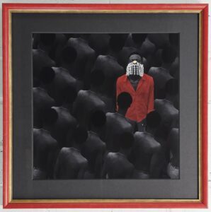 Photograph of seemingly downtrodden shirtless black skinned figures looking downward from a three quarters back view. One figure is facing the camera in a vibrant red shirt with a stringed shell mask with gold details. Framed in a grey to match the skin and a vibrant gold and red traditional frame.