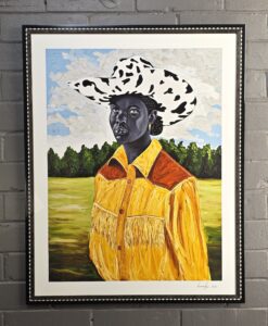 Otis Kwame Kye Quaicoe, figure in yellow western shirt with fringe yellow fringe and a sienna yolk. Figure is painted as grey and wearing a cow spot cowboy hat. Figure is in field with trees in the distance. Print is signed and numbered. Frame has mother of pearl inlaid into a gloss black flat face.