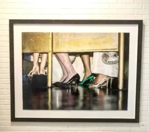 A picture of two women 's feet and one woman 's shoes.