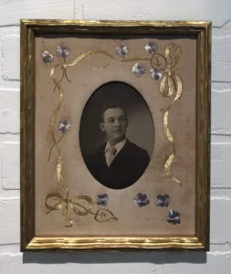A picture of an old man in a frame.