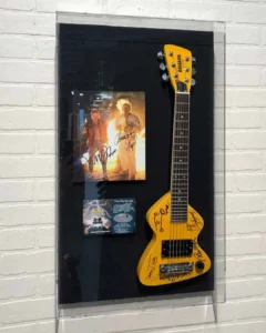 Acrylic Box, A guitar that is hanging on the wall.