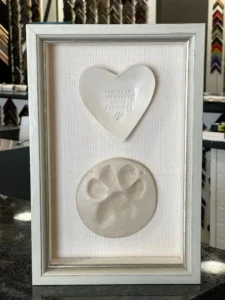 A white frame with a heart and paw print in it.
