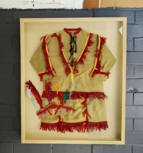 A framed picture of an indian outfit.