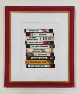 A framed picture of various tapes stacked on top of each other.