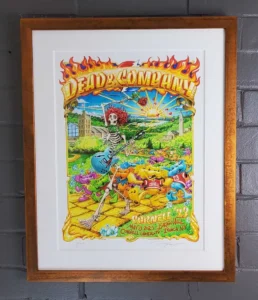 A framed poster of dead and company