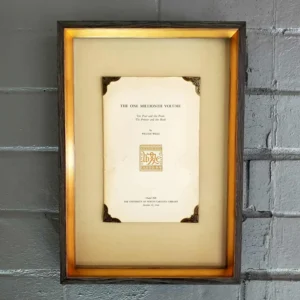 A framed document hanging on the wall.