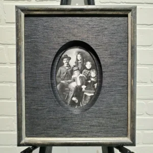 A picture of three people in an oval frame.